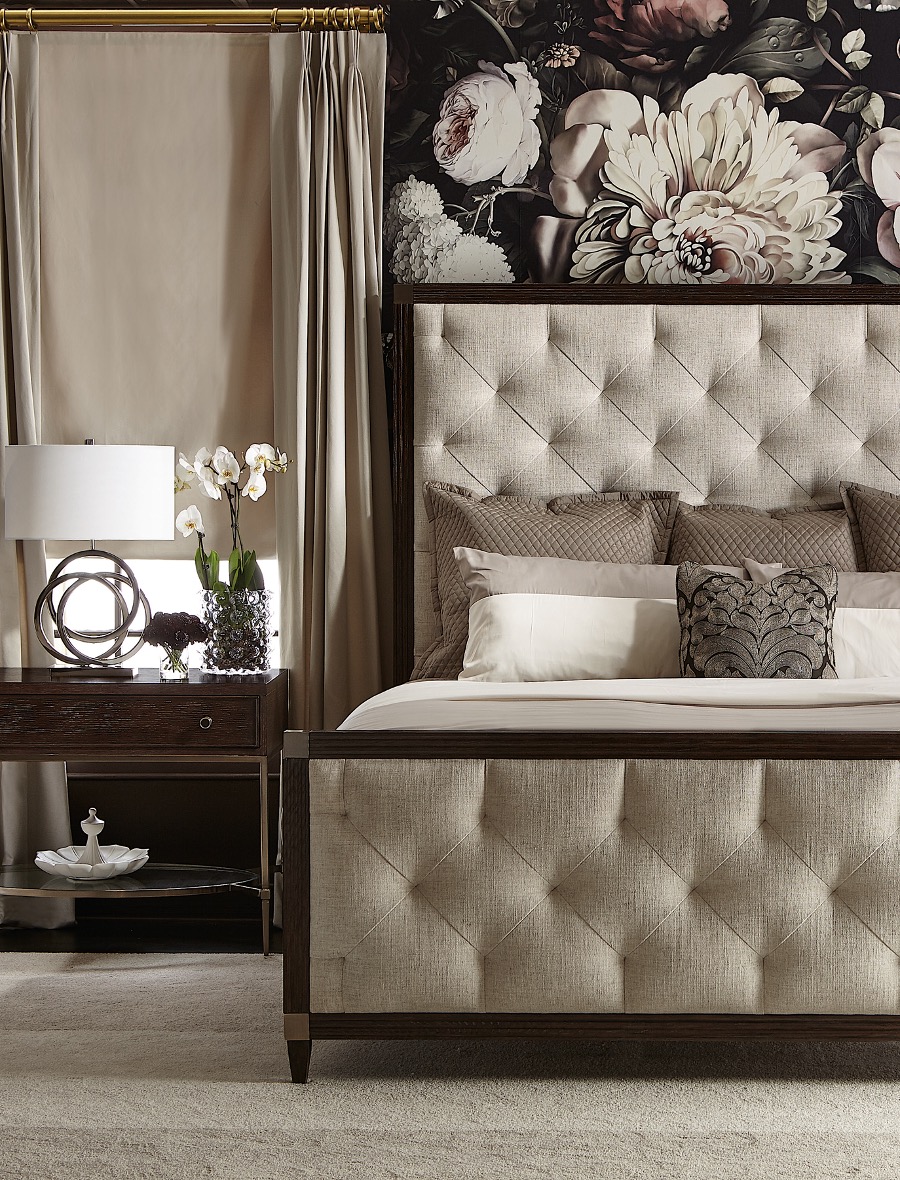 A bed with a floral wallpaper above it. Elevate your living experience with Michelle Jett - Decorating Den Interiors.