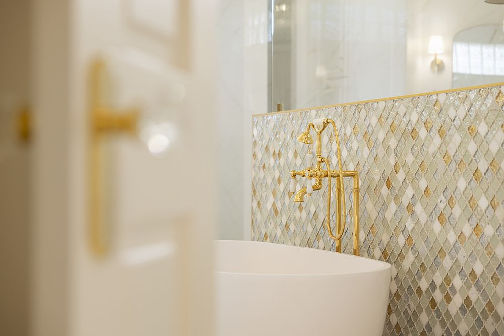 Stunning mosaic tile and gold fixtures create warmth and luxury.